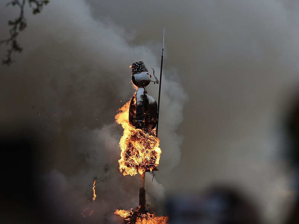 The Böögg snowman effigy mid-burn at Sechseläuten 2023, smoke rising from the pyre